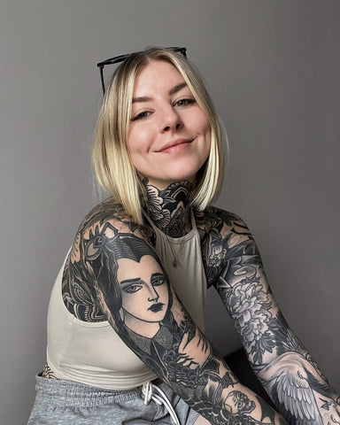 Woman with tattoos smiling
