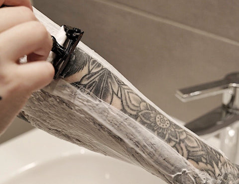 Shaving arm tattoo