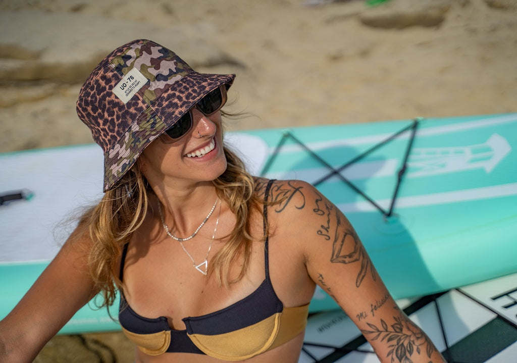 Smiling tattooed woman on the beach