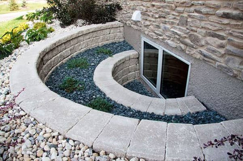 round tiered stone wall in an egress window well