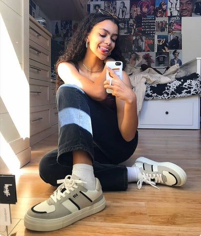 Girl with streetwear style wearing chunky platform vegan sneakers in grey