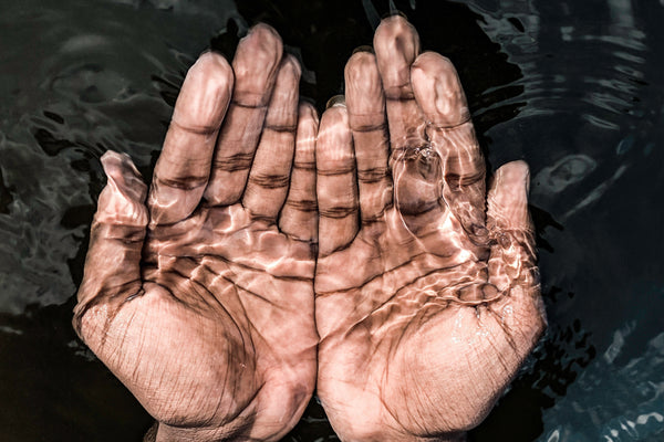 Two hands underwater representing natural life and skincare