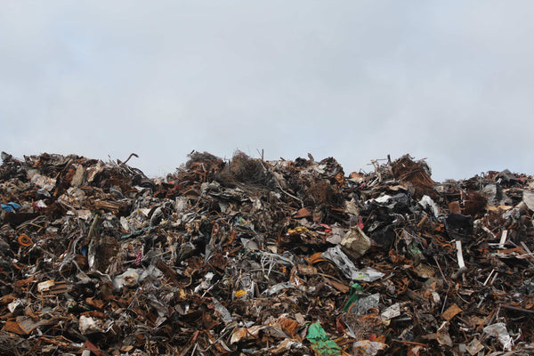 View of landfill from below showing vartious btis of trash like footwear, metal parts and components