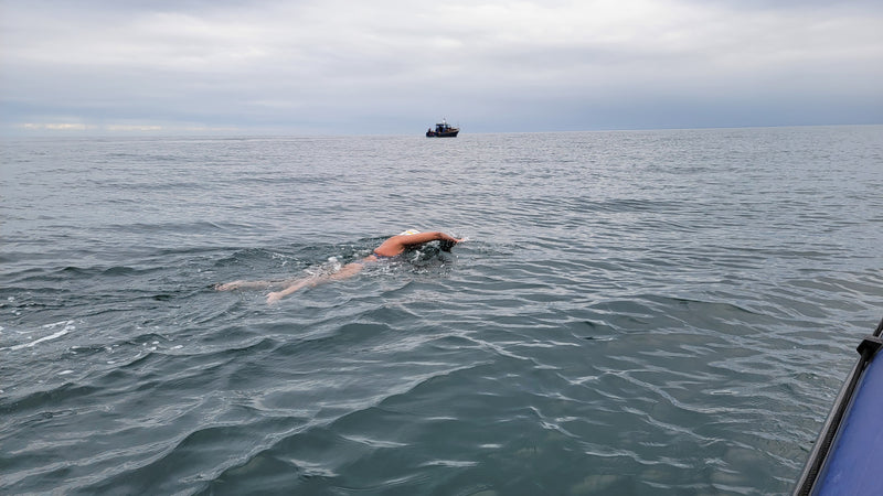 Bárbara Hernández Huerta  swimming  in the sea from the view of a boat