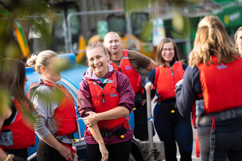 People smiling and wearing life jackets for SUPing