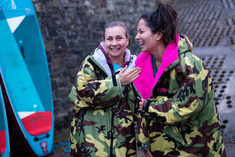 Two people in dryrobes laughing