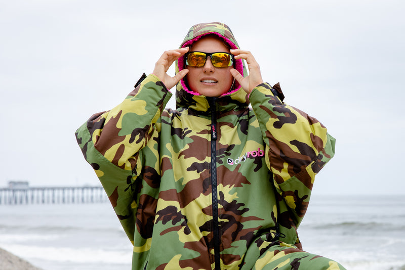 Izzi Gomez wearing a Camo Pink dryrobe Advance and sunglasses at the beach