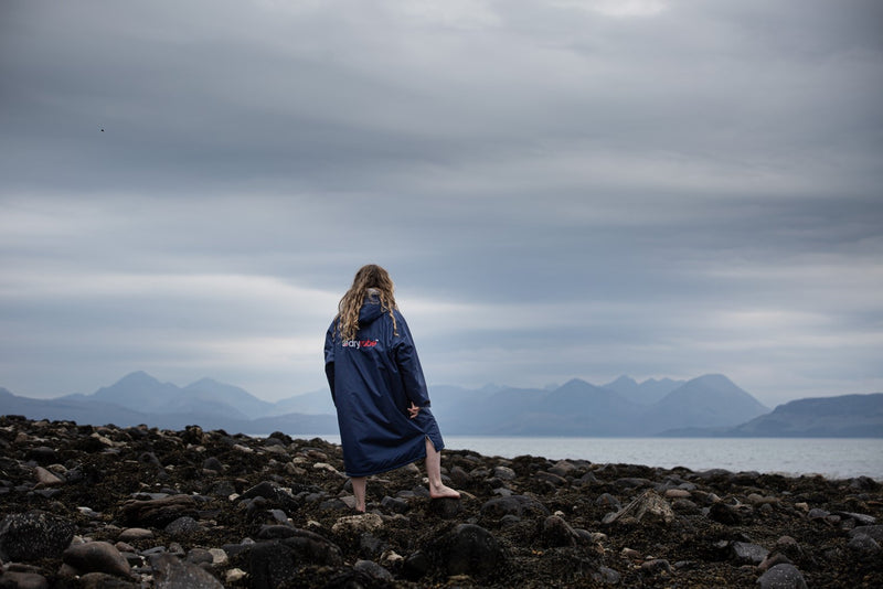 Cal Major stood by the sea wearing a dryrobe® Advance changing robe