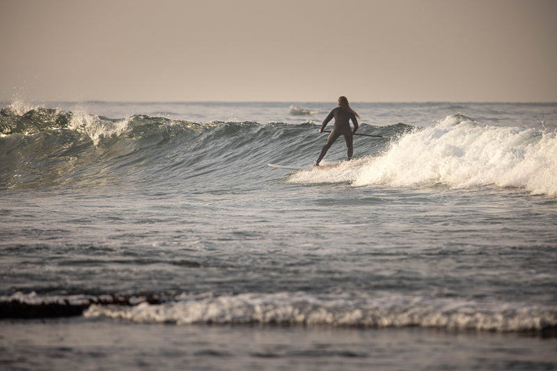 A surfer riding a wave surfing 