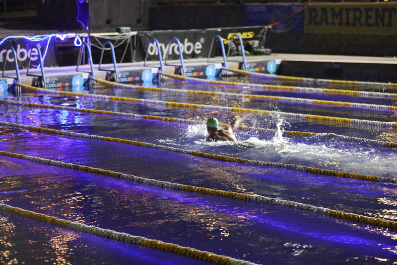 Outdoor pool at night time lit up with LED lights