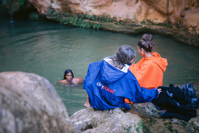 A man swimming in the a natural pool