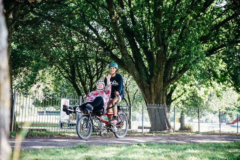 A person on a RORO bike waving 