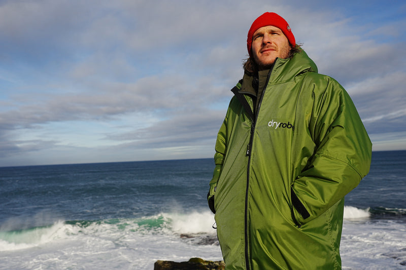 Tas Knight stood by the coast in a dryrobe 