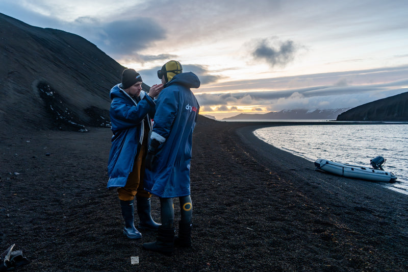 Two people in Antartica wearing dryrobes