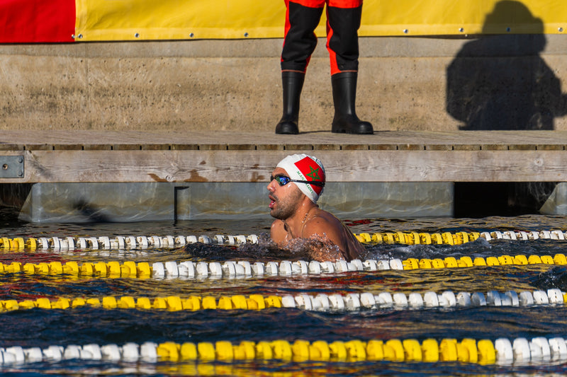 A swimmer swimming in an outdoor pool