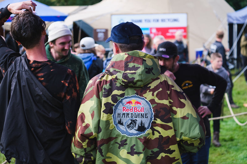 A man wearing a Red Bull Hardline branded dryrobe® Advance 