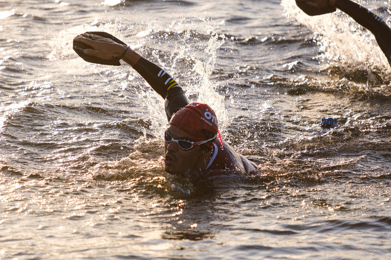 Two swimrunners, swimming at sunrise