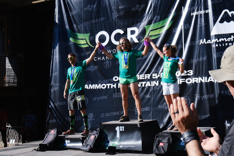 The top fundraisers for OCR Gives Back stood on top of a podium at OCRWC 2023