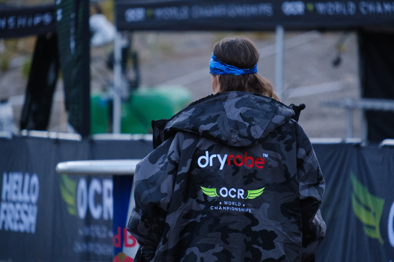 Woman wearing a grey camo OCRWC dryrobe® Adavnce