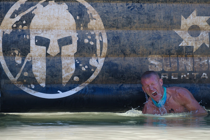 Man coming up from under a Spartan Dunk Wall at OCRWC 2023