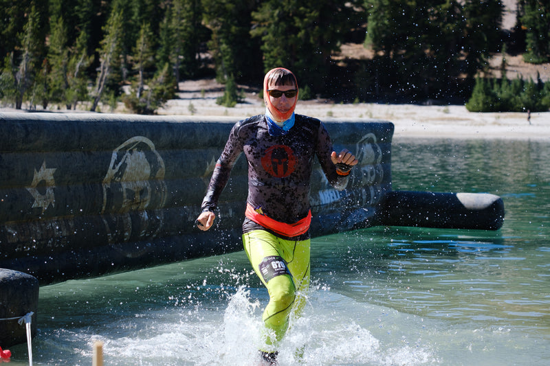 A man running through a lake in Mammoth Mountains at the OCR World Champs