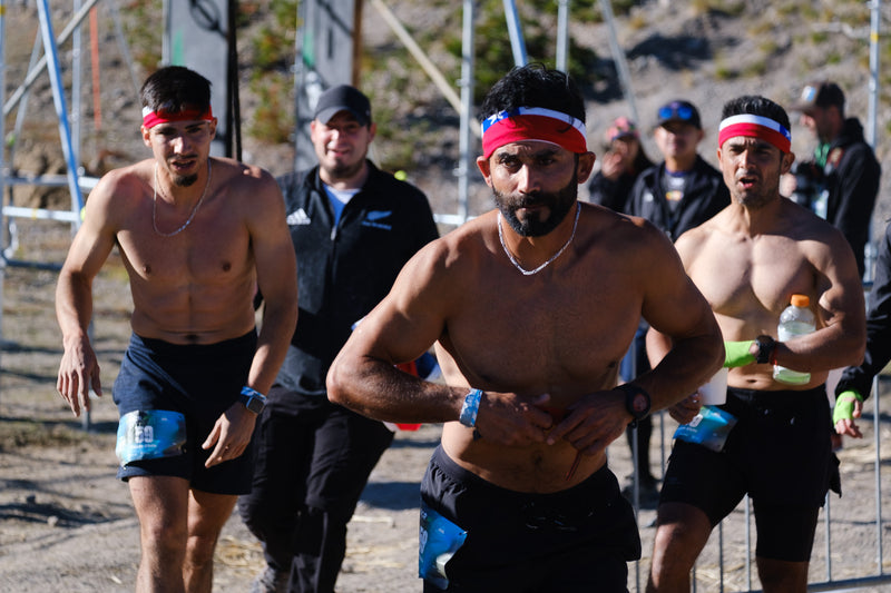 Three Realy team racers, wearing matching headbands, getting ready to run together at the OCRWC in Mammoth Lakes