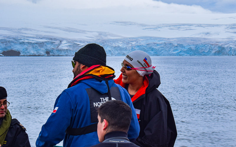 Ice marathon swimmer Bárbara Hernández Huerta on boat wearing dryrobe, cap and swimming goggles in boat in Antarctica