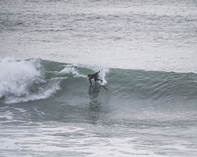 Mini Cho surfing a wave in the sea 