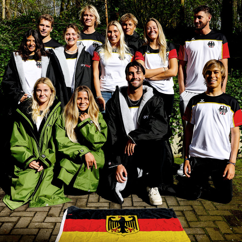 A group photo of the German surf team wearing team kit and dryrobe changing robes