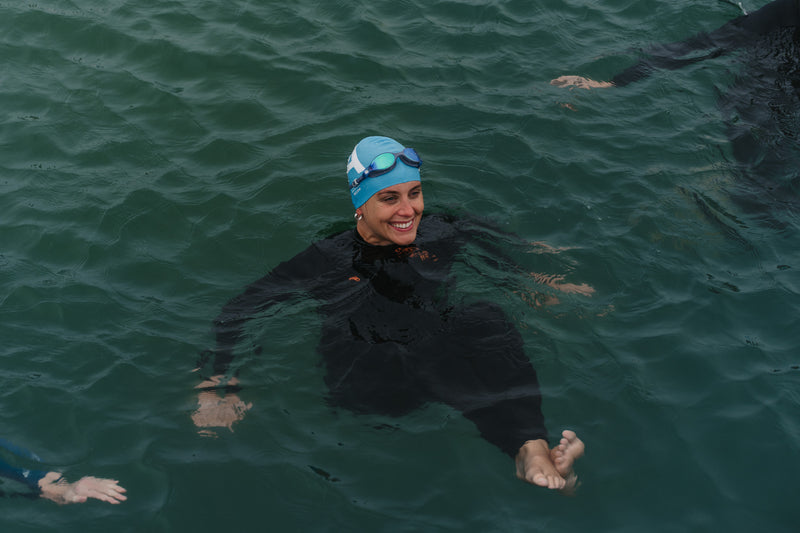 Sophie Hellyer swimming in the sea in a wetsuit and swim cap 