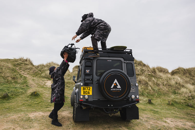 Ben and Lukas Skinner unloading gear from their Arkonik Land Rover Defender