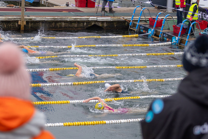 Swimmers in an outdoor pool swimming