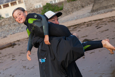 Child being carried off the beach