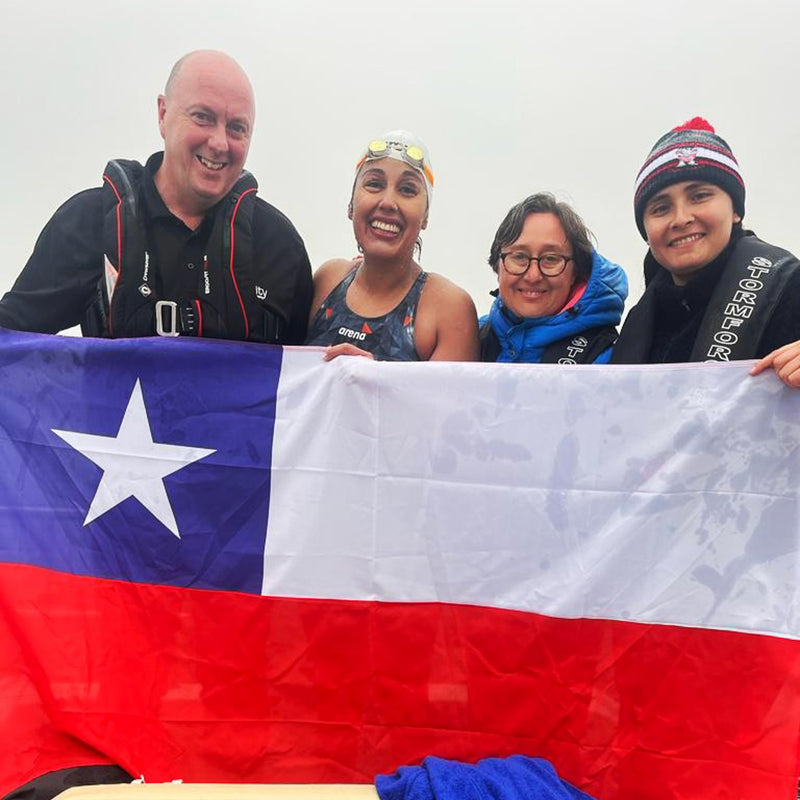Bárbara Hernández Huerta and her team stood holding the Chilean flag after she completed a swim