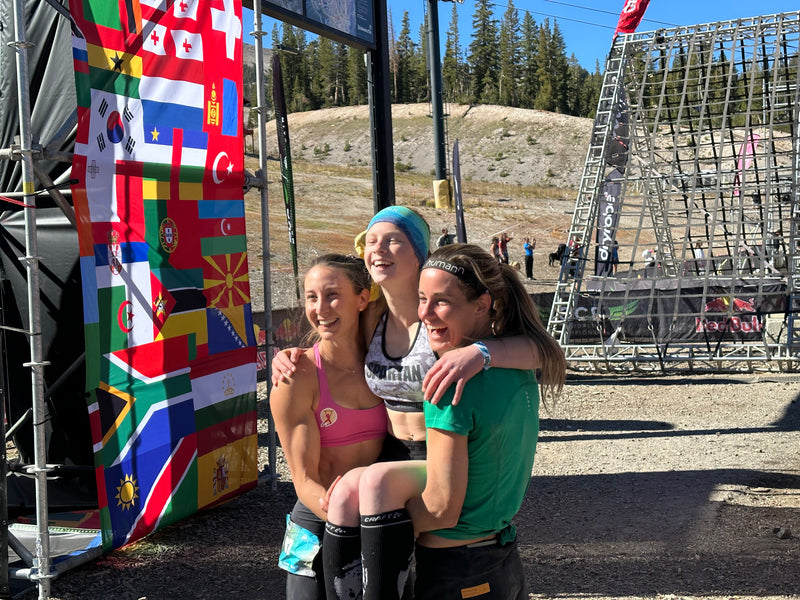 Nicole Mericle and Lindsay Webster hold team team mate Libbie Joyce at the finish line of OCRWC in Mammoth Mountain