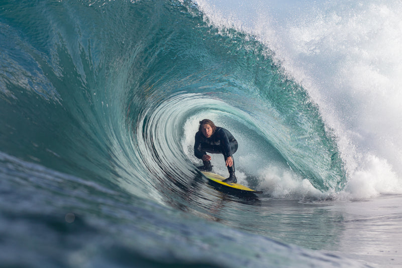 Taz Knight surfing a massive tube