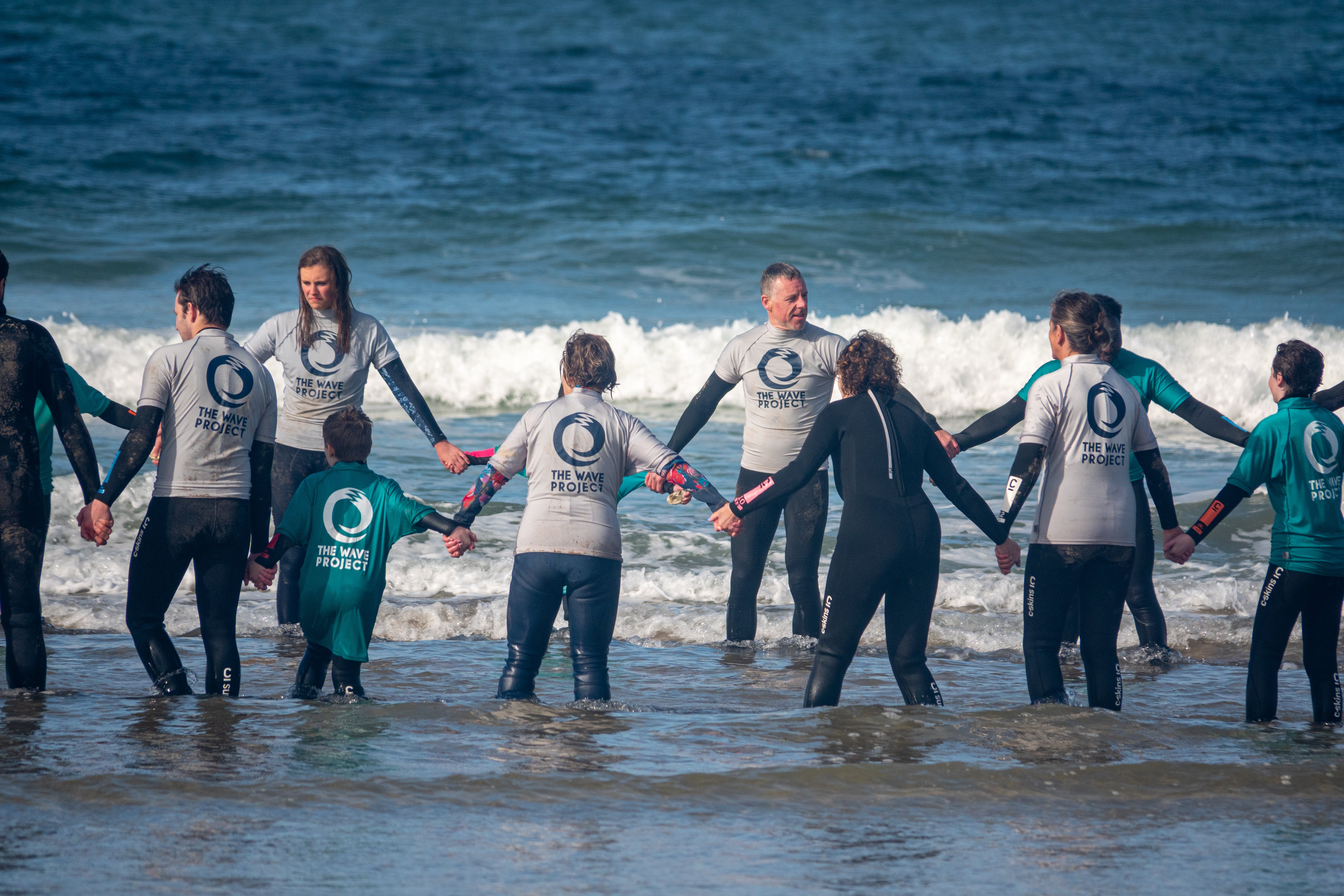 A group from The Wave Project stood in a circle holding hands