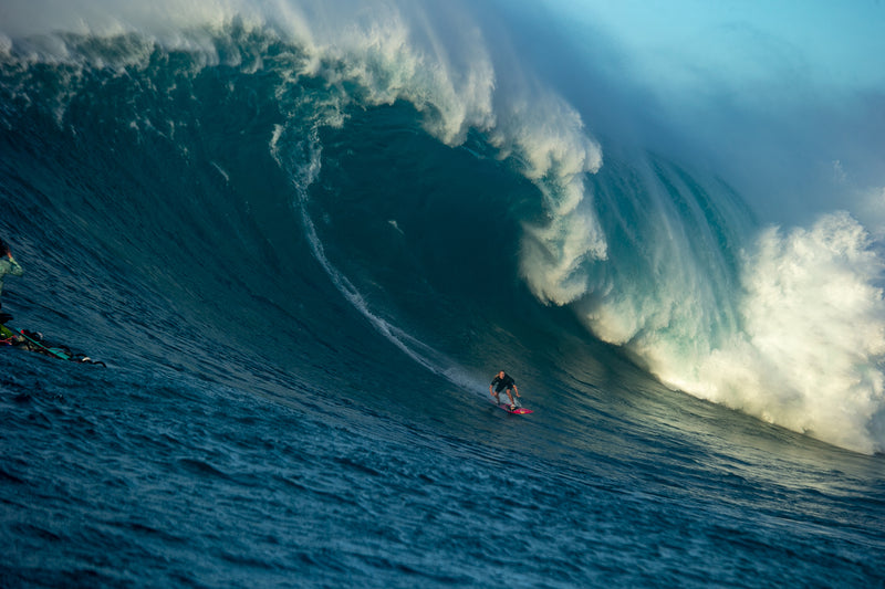 Izzi Gomez surfing a huge wave at Jaws