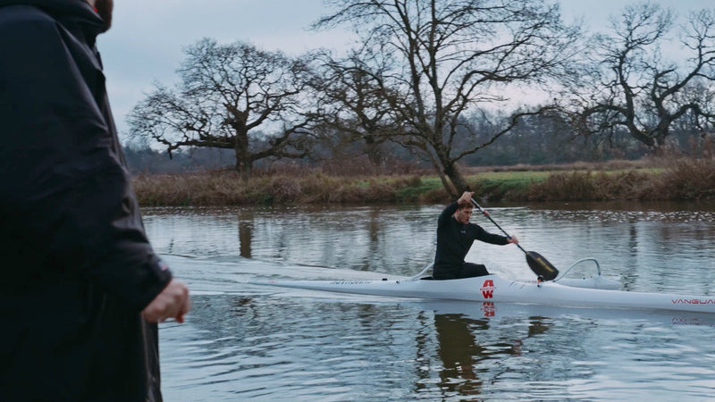 Jack Eyers paddling a canoe in a river 