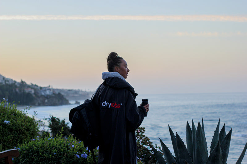 Lexie Kelly stood at sunrise at a beach in a dryrobe