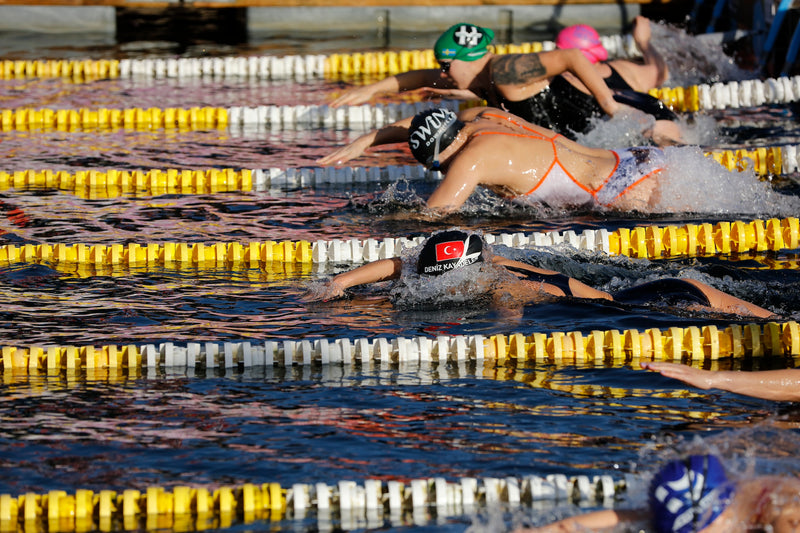 Swimmers swimming in an outdoor pool