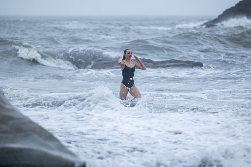 A woman coming out of the sea after a swim