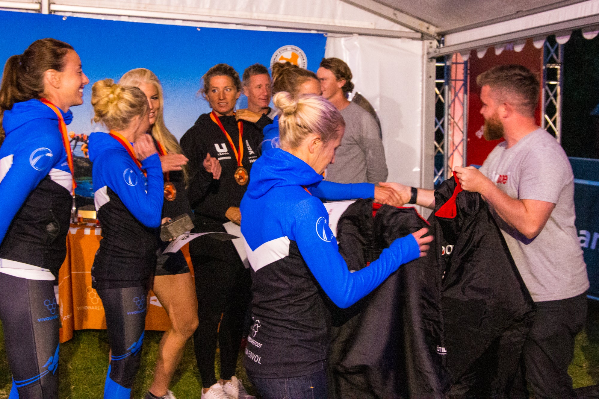 Winning women's teams collecting their ÖTILLÖ dryrobe prizes - ÖTILLÖ Swimrun World Championship 2019