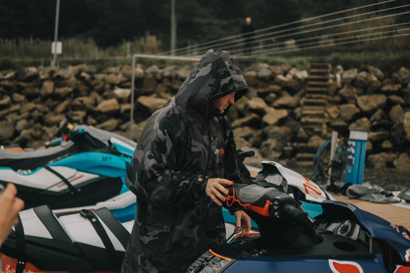 Big wave surfer Andrew Cotton stood by a jet ski in a dryrobe