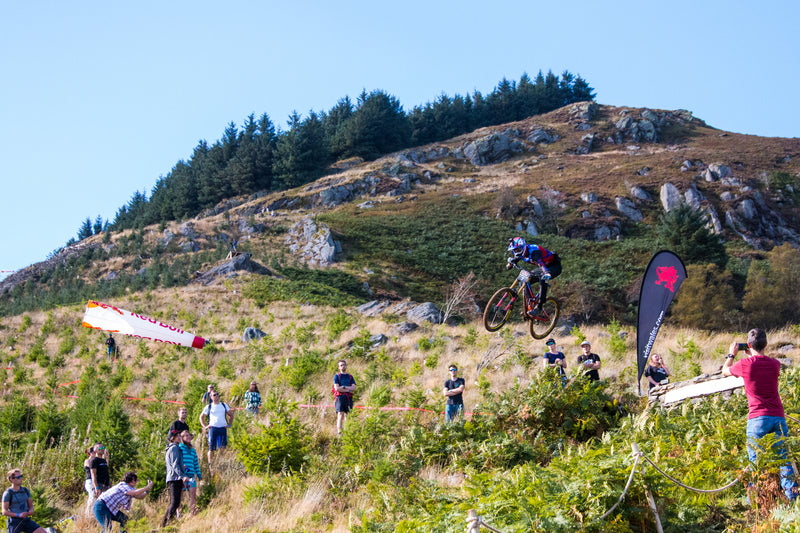 A racer biking down a hill at Red Bull Hardline 