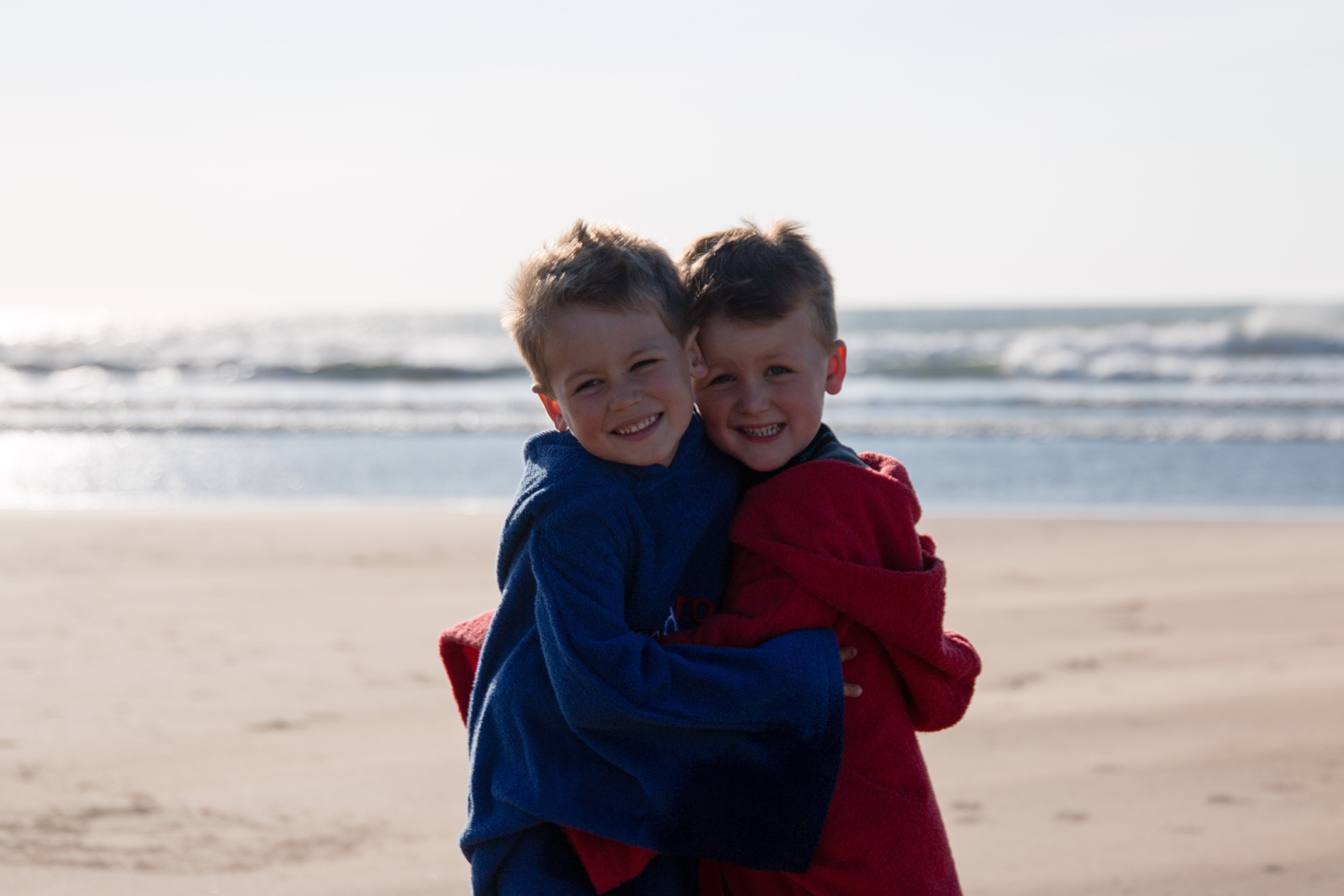 Children hugging on the beach