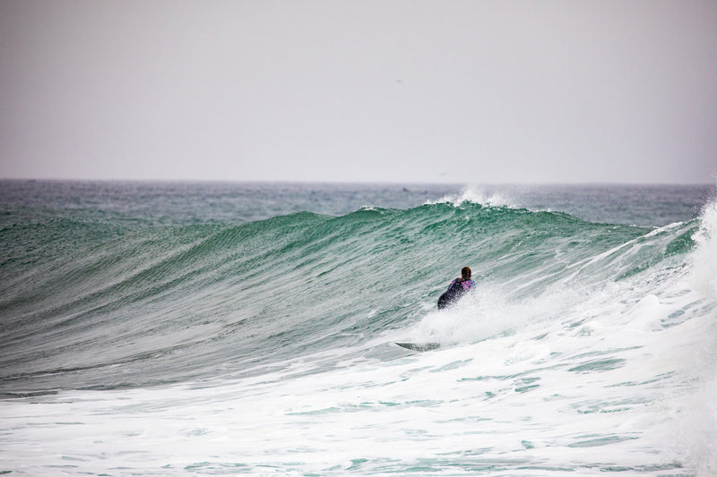 Lucy Campbell surfing in the windy sea