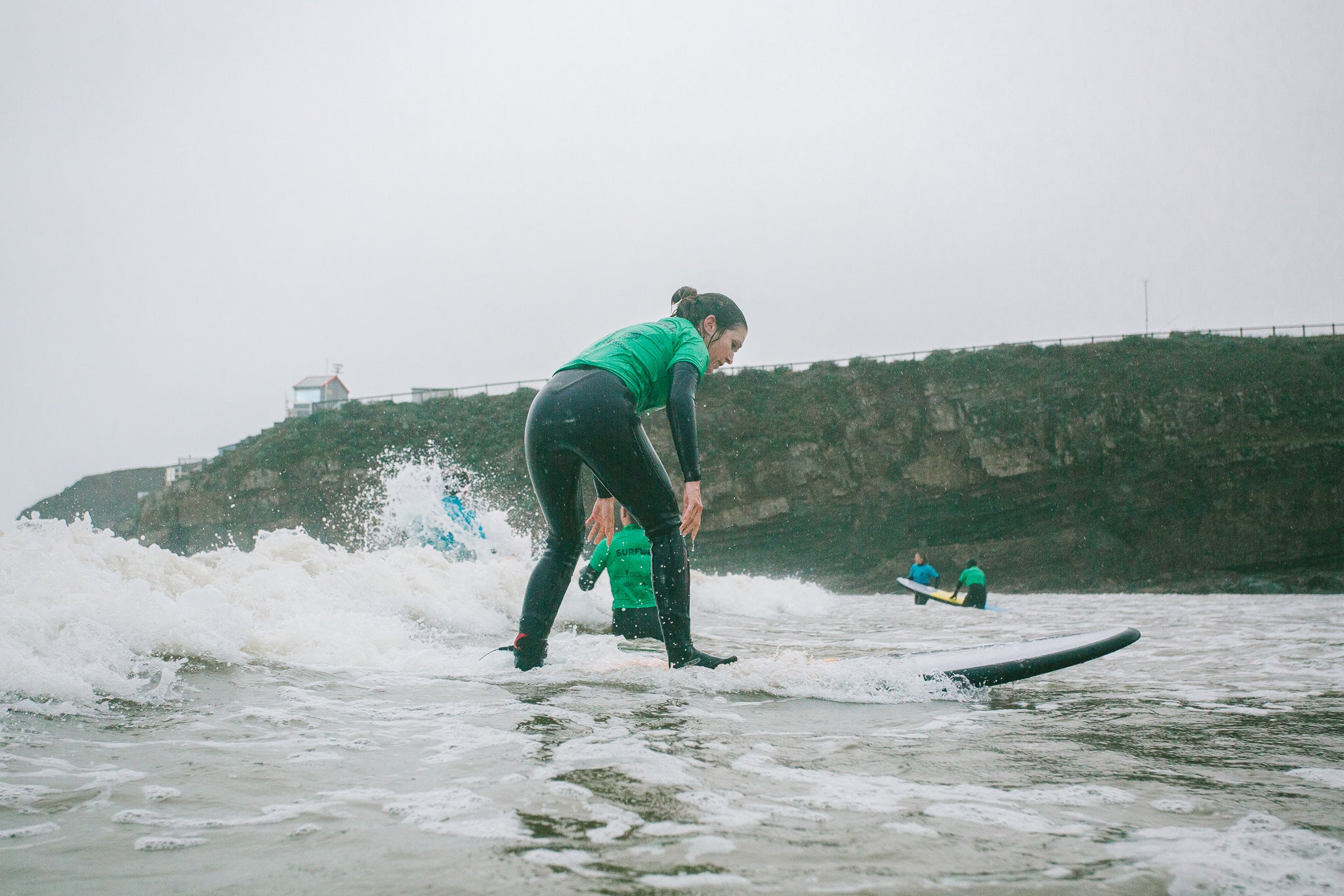 Surfwell participant surfing  in the rain