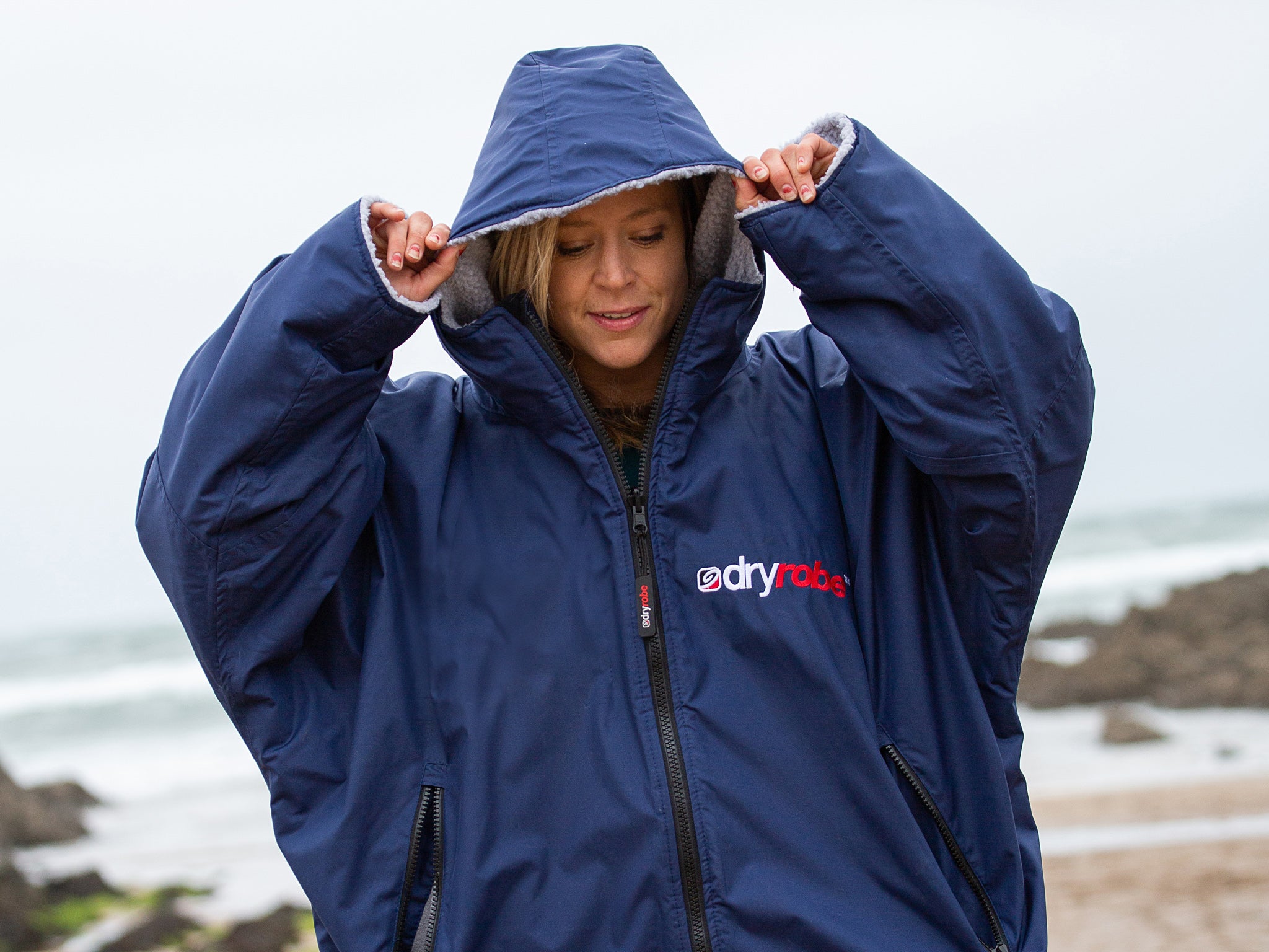 Jenny Jones wearing a dryrobe Advance on the beach