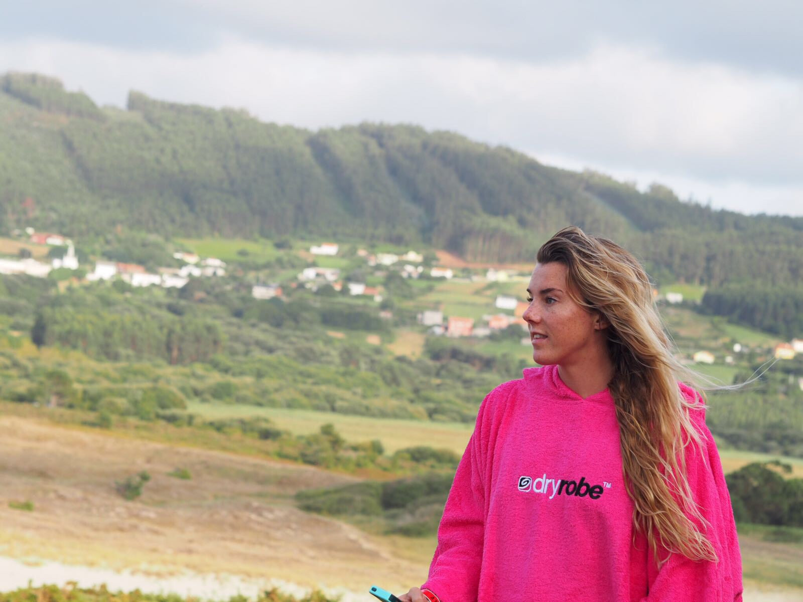 British surf champion Lucy Campbell wearing a pink towel dryrobe